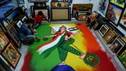 Artists create Hindu ritual artwork depicting India as a mother goddess holding the national flag and a symbol of the COVID-19 pandemic on the country's Independence Day on the outskirts of Ahmedabad on Aug. 15, 2020.