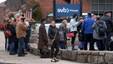 Following Silicon Valley Bank's collapse, customers line up outside a branch in Wellesley, MA, on March 13, 2023. (David L. Ryan/The Boston Globe via Getty Images)